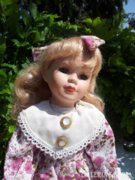 Doll with blonde porcelain head.