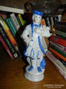 Porcelain musician in baroque dress with a bird
