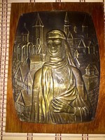 Beautiful Russian copper relief on a wooden background