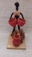 A bent negro female figure with a basket and a dog, handmade from retro marked wire