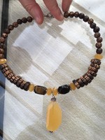 Silver necklace with a honeysuckle necklace, a tiger eye stone and a wooden bead