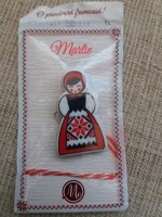 Matryoshka baby brooch badge in unopened packaging.