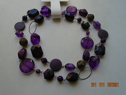 With shades of purple, bronze rose and mineral, a novel necklace made of 12 different pearls