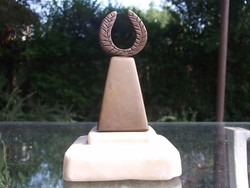 A bronze statue with a laurel wreath on an alabaster base, also excellent as a prize