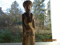 The Chinese emperor with a decorative sword is a handmade statue