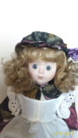Antique porcelain doll with a hat, 40 cm high, in excellent condition