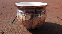 A potted ceramic vase with a glossy flow glaze