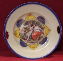 A porcelain serving bowl with a romantic scene and a viable handle