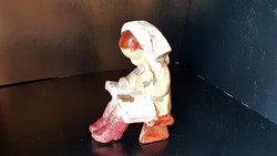 Antique sitting reading girl, porcelain figure.