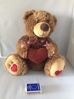 Very cute, soft teddy bear with a heart and a bow