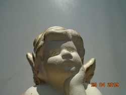 Thinking putto with gilded wings, glazed terracotta