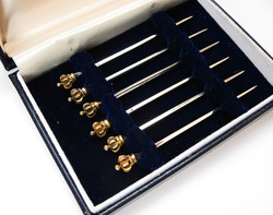 Crowned, gilded silver cocktail sticks.