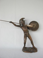 Metal statue of an ancient soldier throwing a spear