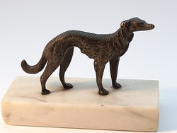 Bronze dog sculpture on marble soles