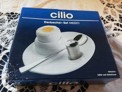 Old porcelain cilio brand soft egg holder with metal salt holder and spoon in its own box for sale.