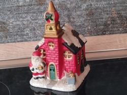 Santa in church holding Christmas scented candle