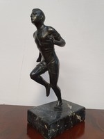 Running man with bronze statue on marble base