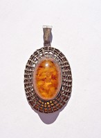 Amber stone pendant with openwork pattern in 835 silver frame