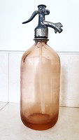 Old soda bottle with pink saline soy bottle