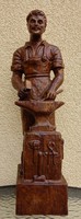 Wooden statue of blacksmith master