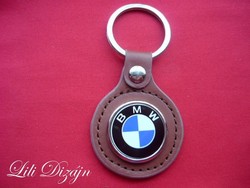 BMW circular metal keychain on a leather background