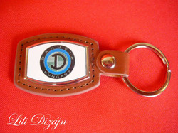 Danuvia (motorized) metal keychain on a leather background