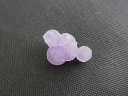 Spherical purple quartz crystals are a natural mineral. (Grape agate).