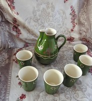 Set of hand-painted ceramic drinks on a folk green background - jug and six glasses