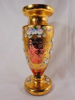 Bohemian red amphora in enameled gold-painted glass vase.