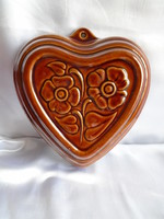 Heart-shaped, flower-glazed ceramic baking dish.