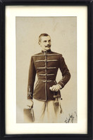 Antique photo, paper picture framed. Young Hungarian officer in uniform with sword, studio shot.