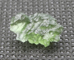 Olive green Moldavit meteorite impact glass grain. Rare, naturally formed piece.