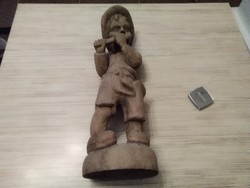 Large sculpture of a little boy with a flute.