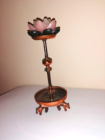 A work of applied art. A candle holder standing on a mace.