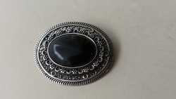 This time the brooch badge is decorated with onyx stone