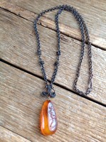 Old handcrafted necklace with amber stone