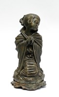 Praying girl with metal statue