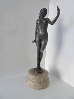 Antique tin marked nude sculpture on marble base.