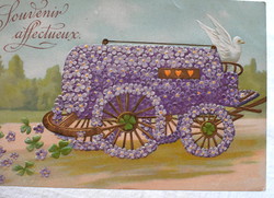 Antique embossed greeting postcard with flower car spraying clover flowers
