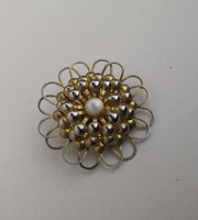Old brooch badge adorned with white stone
