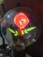 Retro glimm lamp with glowing rose