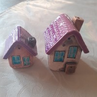 2 ceramic houses with purple roofs