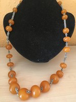 It was made of amber necklaces - with Russian-metal fittings - in the 1950s and 1960s