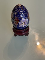 Beautiful collectible small compartment with Chinese egg in wooden holder.