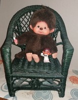 Moncsicsi in a cane armchair with a small rubber munchkin