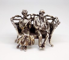 Miniature couple sitting on a silver bench (zal-ag103099)