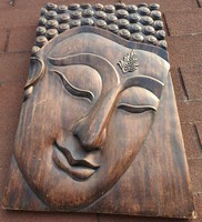 Buddha is a huge, heavy, carved - wooden board - mural