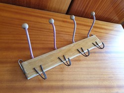 Old vintage wall wire hanger with wooden buttons in hallway hanger