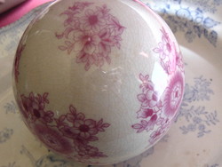 Porcelain sphere with pink floral on a cream-white background