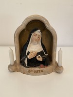 St. Rita statue with candles